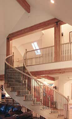 Picture of a finished curved staircase in the model P-801 house plan. 